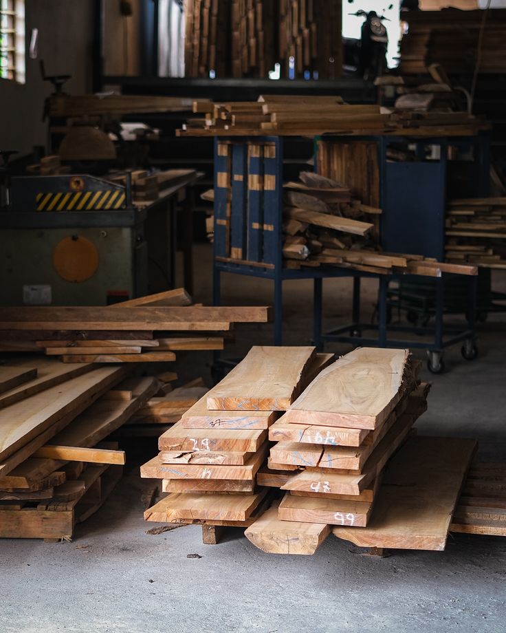 Timber boards stacked for woodworking inside a workshop