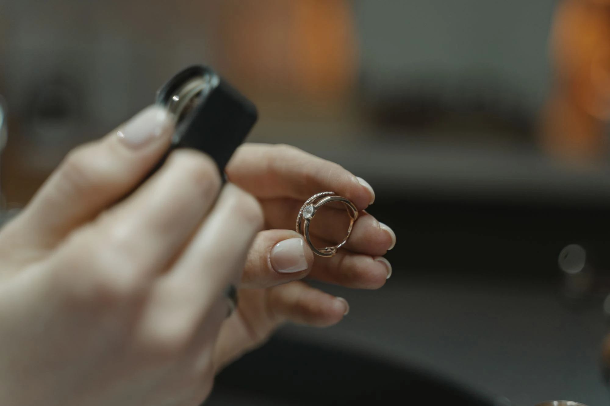 A jeweler examining a stone-set ring with a loupe